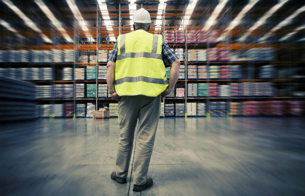 Man looking at goods in chemical warehouse